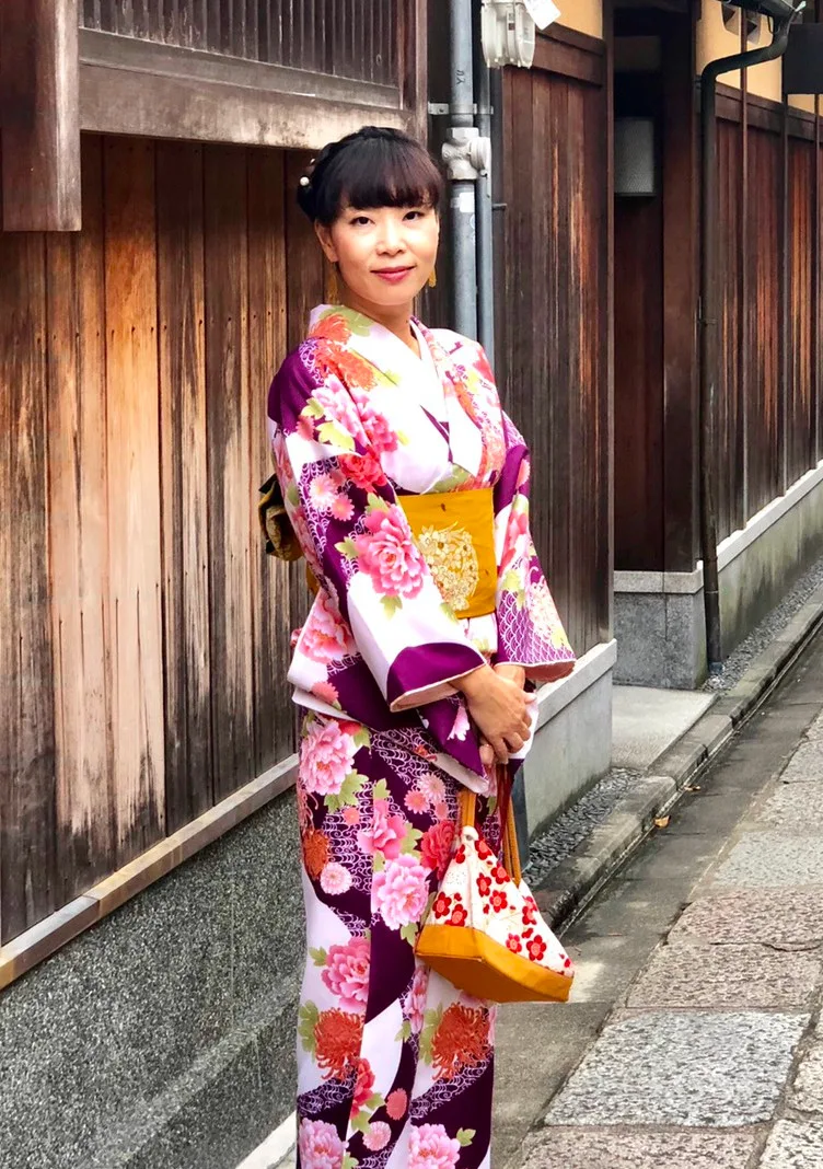 Yuko wearing a kimono on a stone-paved street in Kyoto